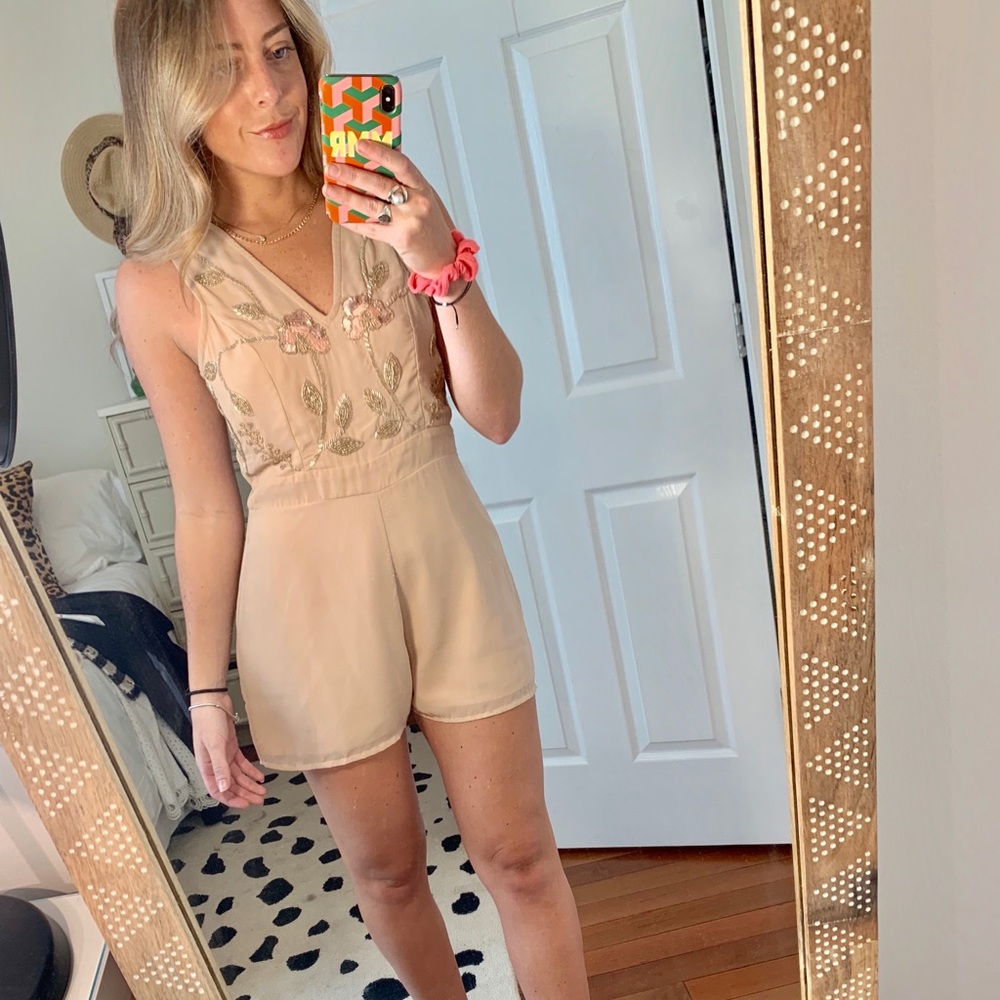 Tan romper with flower embellishment